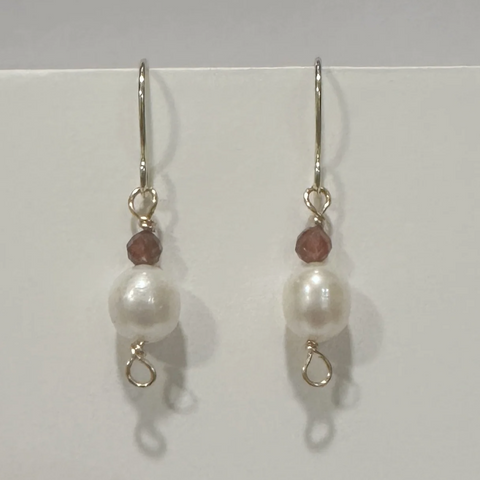 Pair of pearl earrings with small beads on a white background