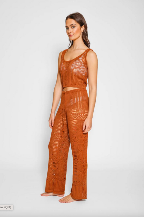Woman wearing a brown crochet outfit on a white background