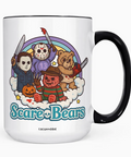 A white ceramic coffee mug with a black handle and black rim, featuring a colorful graphic of five horror-themed bears under a rainbow and the text 'Scare Bears'. The brand name 'COCOANDBIE' is printed below the graphic.