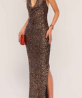 Woman wearing a sparkly evening gown with a red clutch against a white background