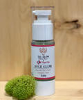Skincare bottle labeled 'Sole Glow' on a wooden surface with green moss.