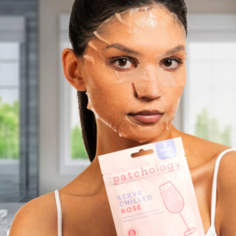Woman applying a face mask with a 'patchology' product in the foreground