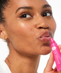 Woman using a pink lip product on a website page with 'Patchology' branding.