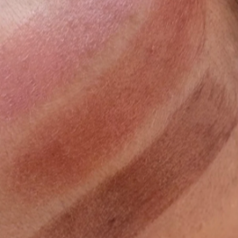 Close-up of a skin swatch with brown and beige tones.