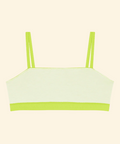 Light green bikini top with thin straps on a beige background