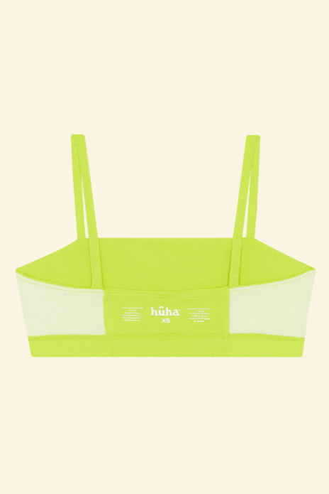 Neon green bikini top with thin straps on a beige background