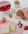 Fragile food packaging with strawberries, cookies, and chocolate on a white surface
