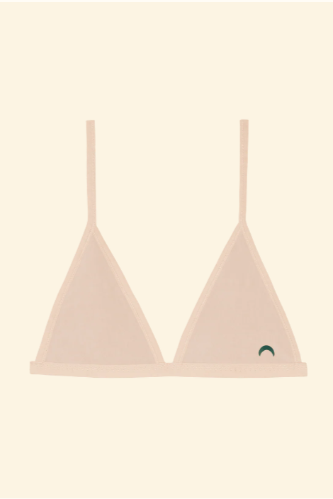 Pink bralette with thin straps on a beige background