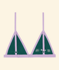 Green bra with purple straps on a beige background