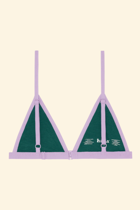 Green bra with purple straps on a beige background
