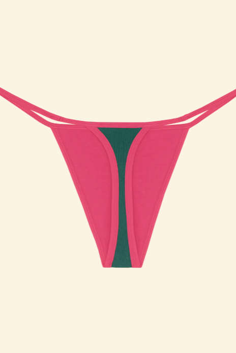 Pink thong with green center on a beige background
