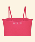 Pink top with thin straps on a beige background