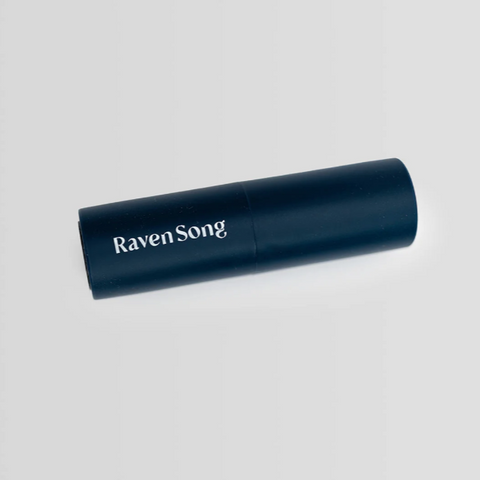 Navy blue cylindrical product with 'Raven Song' branding on a light gray background