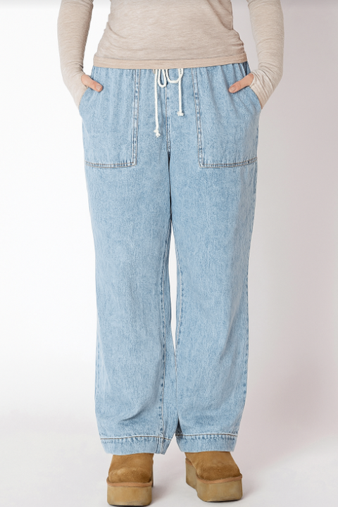 Light blue jeans worn by a person on a white background