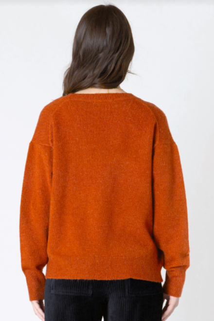 Person wearing an orange sweater on a white background