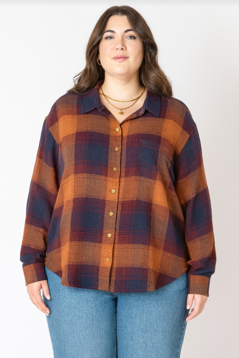 Woman wearing a plaid shirt and jeans on a white background