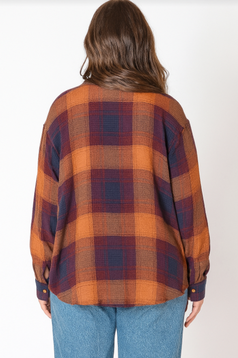 Person wearing a plaid shirt with a white background