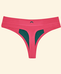 Pink thong with green mesh panels on a beige background