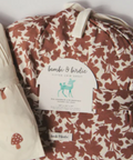 Floral-patterned baby blanket with a label on a white background