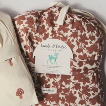 Floral-patterned baby blanket with a label on a white background
