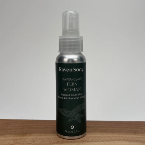 Raven Song room and linen mist bottle on a wooden surface with a white background