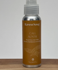 Raven Song Calm Aunty spray bottle on a wooden surface with a gray background