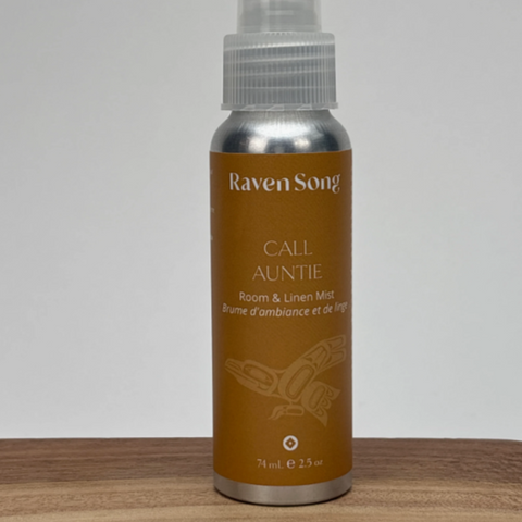 Raven Song Calm Aunty spray bottle on a wooden surface with a gray background