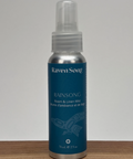 Raven Song Rainsong room & linen mist bottle on a wooden surface with a gray background