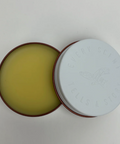 Open round container with a white lid on a gray background