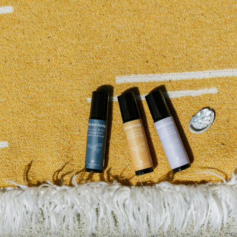 Three cosmetic bottles on a textured surface with a blurred background