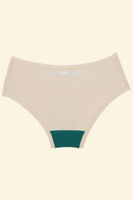 Beige underwear with green waistband on a beige background