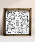Framed artwork with black and white cat illustrations on a beige background