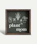 Decorative sign with plant illustrations and 'plant mom' text on a white background
