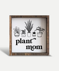 Decorative sign with plant illustrations and 'plant mom' text on a white background