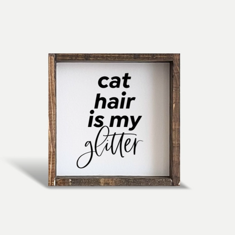 Wooden framed sign with 'cat hair is my glitter' text on a white background
