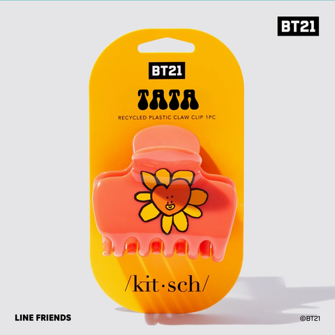 Pink claw clip with yellow flower design on a yellow packaging with BT21 branding.