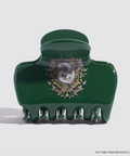 Green hair clip with decorative emblem on a white background