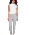 Woman wearing a white sleeveless top and gray leggings on a white background