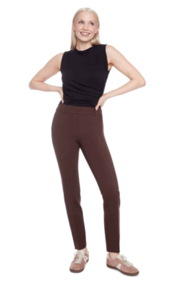 Woman wearing brown pants and a black top on a white background