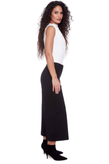 Woman wearing a white sleeveless top and black skirt on a white background
