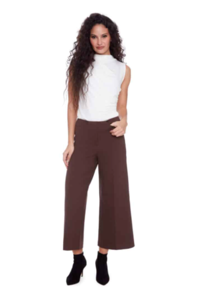 Woman wearing a white sleeveless top and brown pants on a white background with 'i love tyler madison' text.