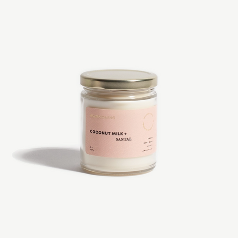 Candle jar with a pink label on a white background