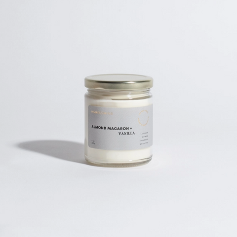 Candle jar labeled 'Almond Macaron Vanilla' on a light gray background
