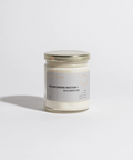 Candle jar with a label on a white background