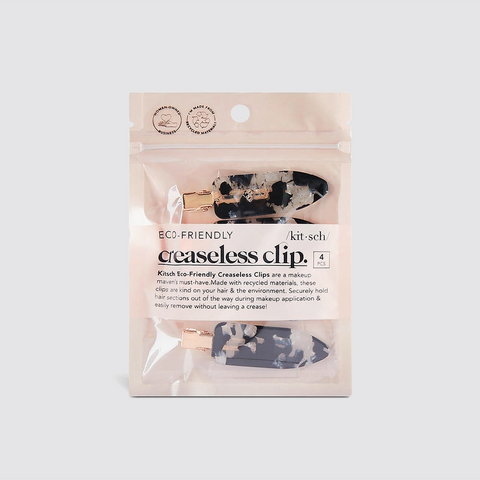 Packaged eco-friendly creaseless clips with visible branding on a white background