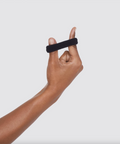 Hand holding a black fitness tracker against a white background