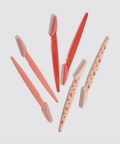 Set of pink and red makeup brushes on a light gray background