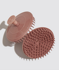 Pink silicone scrubber on a light gray background