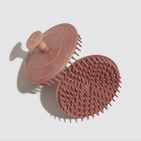 Pink silicone scrubber on a light gray background