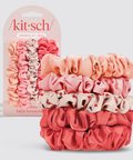 Set of pink satin scrunchies with packaging labeled 'kitsch' on a light gray background.